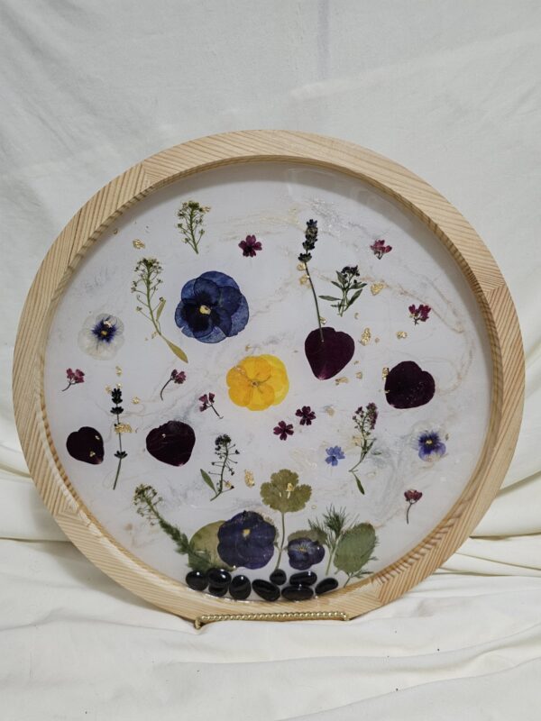 Round Wall art made of Pressed flowers and resin with rocks at the base. Blue Tones