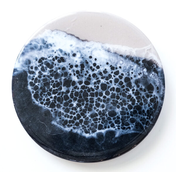 Dramatic black resin with subtle wave-like textures, evoking the mystery and alure of the deep sea at night.