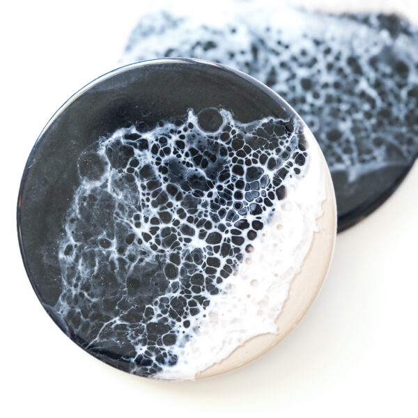 Dramatic black resin with subtle wave-like textures, evoking the mystery and alure of the deep sea at night.