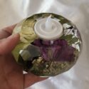 Wide votive holder made with flowers that is faceted